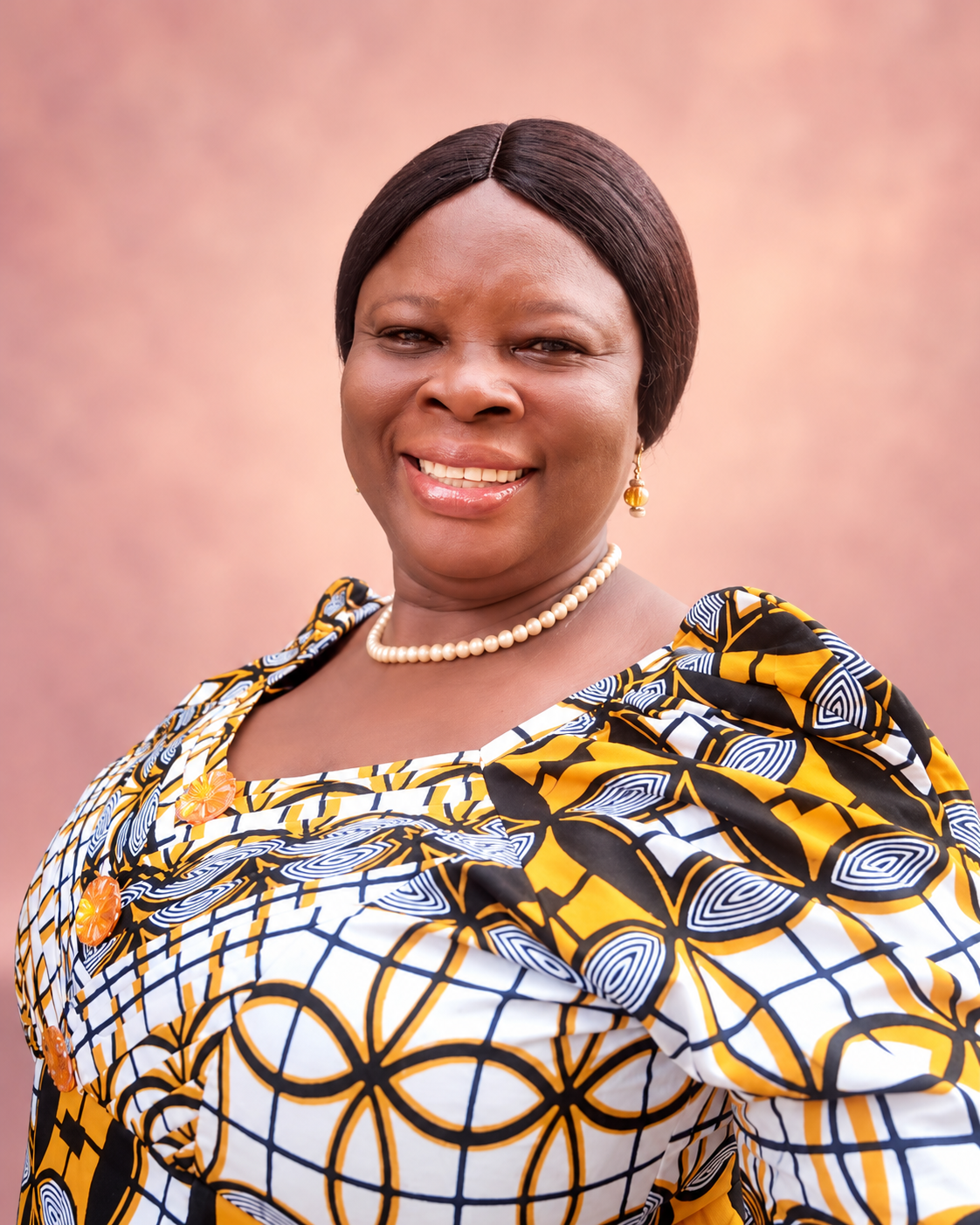 Rev. Mrs. Elizabeth Ayembilla in a yellow, black and white African dress
